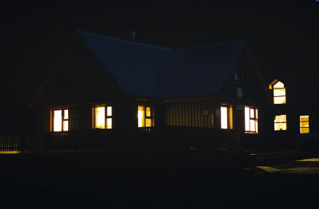 House at night with internal light through windows