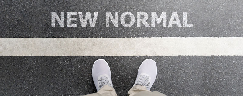 Feet next to white line with the other side of the line saying new normal