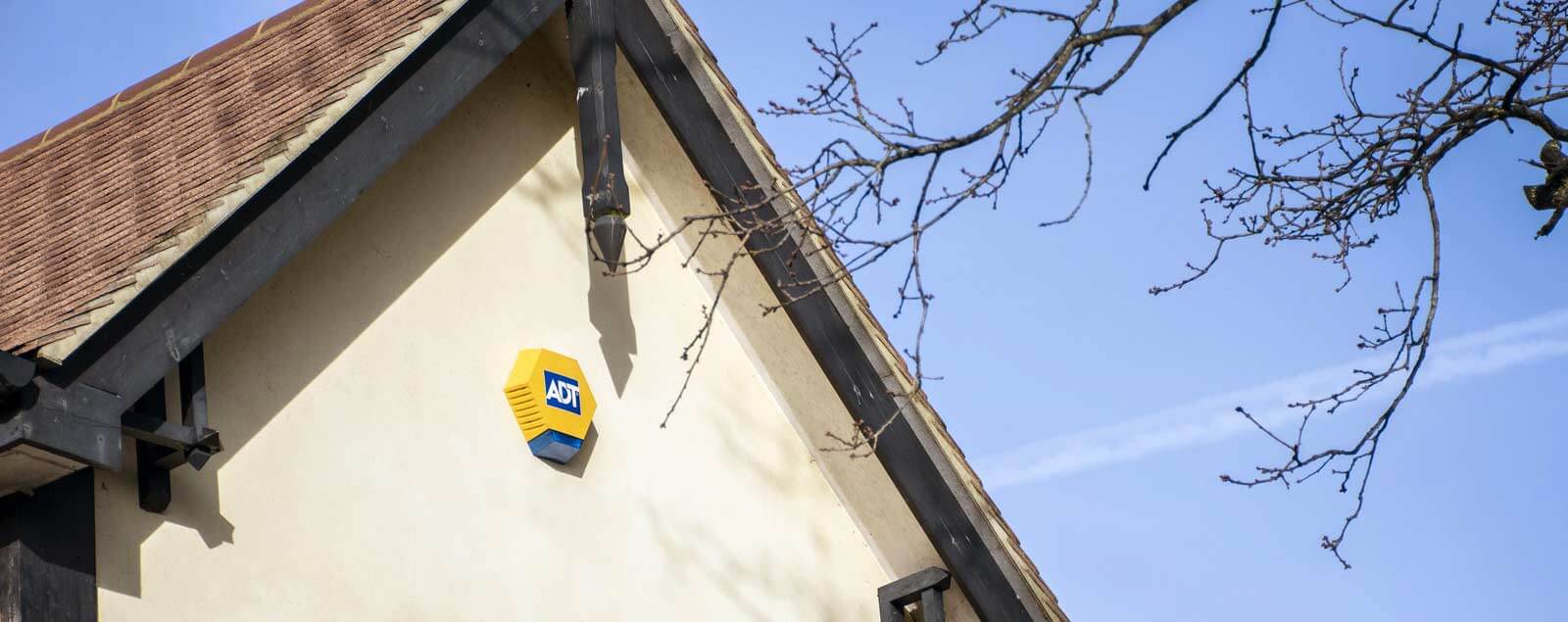 ADT alarm mounted on exterior wall