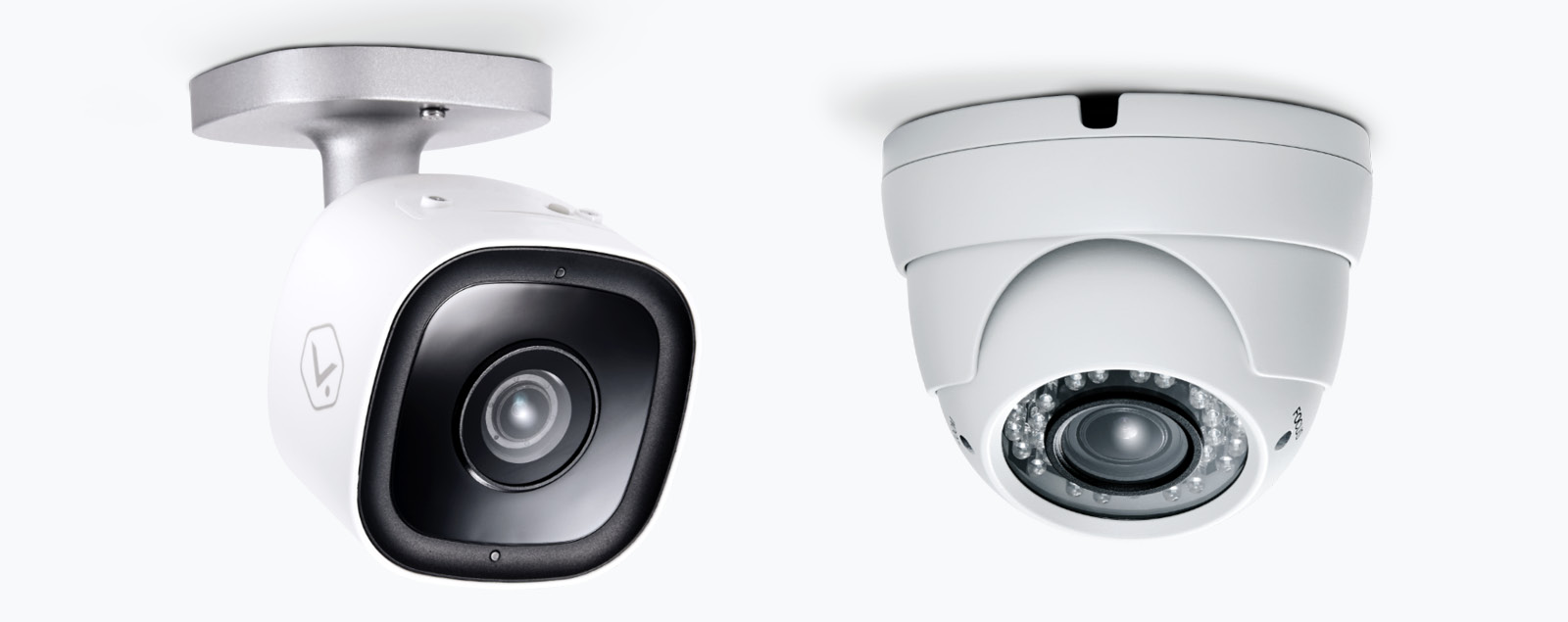 Two white, ceiling-mounted home security cameras