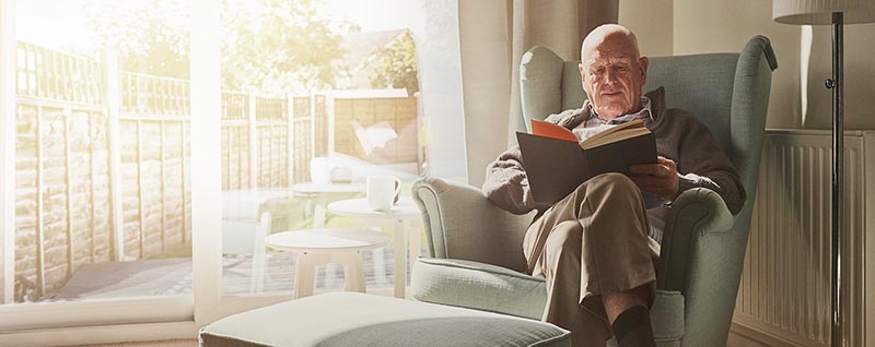 Man reading in armchair