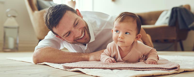 Dad with baby on rug