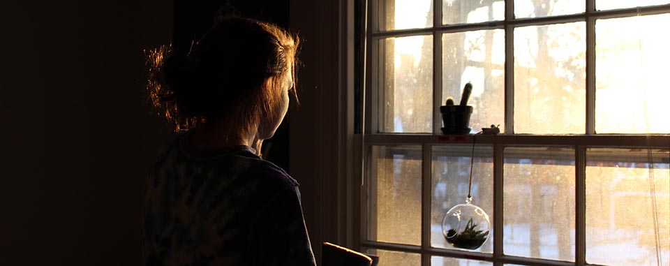 Lady looking out of window