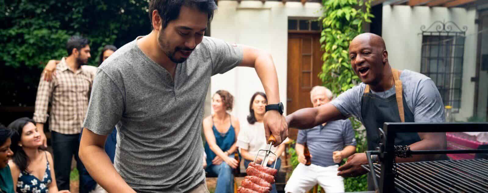 Barbeque gathering with men cooking