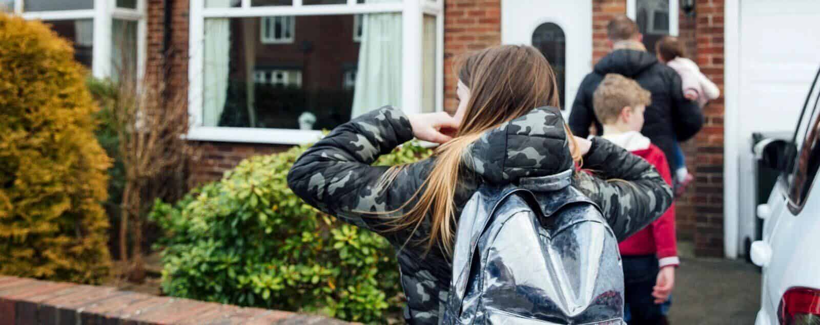 Family outside entering home