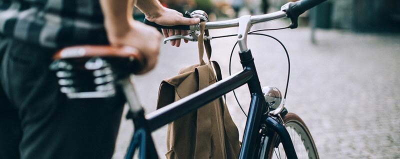 Close up of man walking with bike