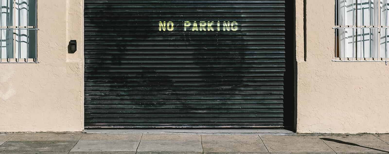 Building shutters with text no parking written