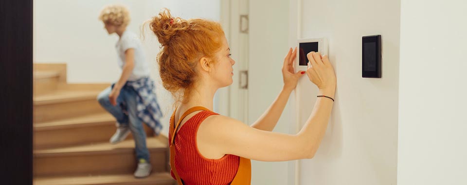Lady using wall-mounted security interface panel