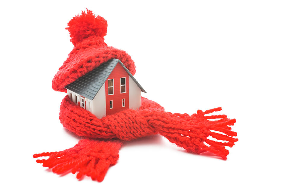 Model house wrapped in red scarf and hat