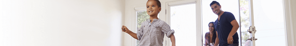 Family walking in to the house through the patio doors mobile header full width