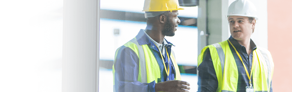 Men in hardhats and hi-vis talking