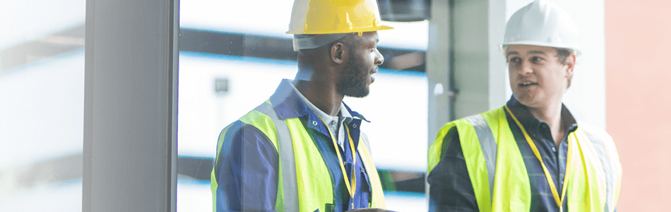 Men in hardhats and hi-vis talking