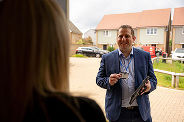 Smiling salesman at door