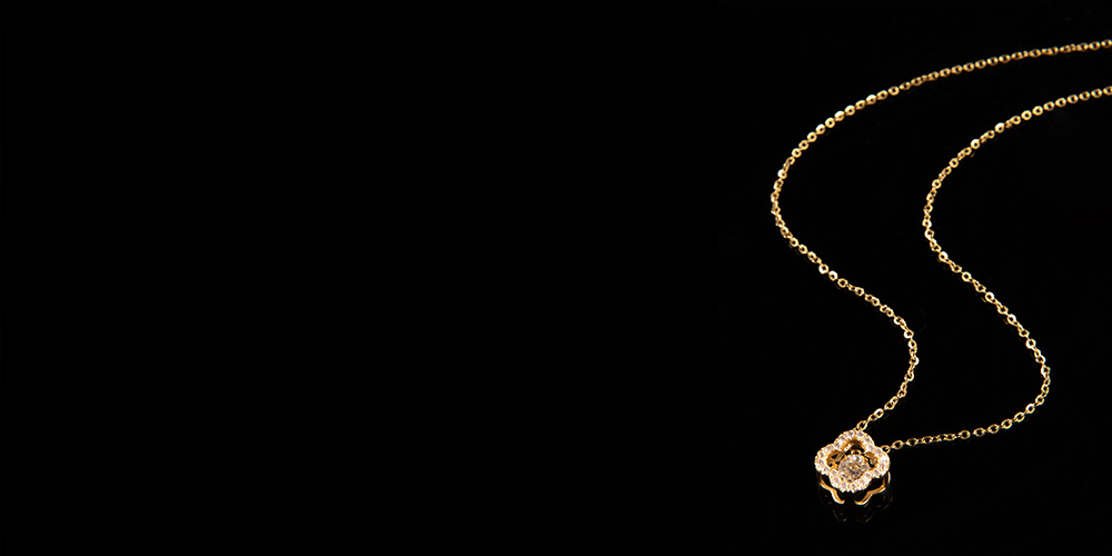 Gold necklace on black background