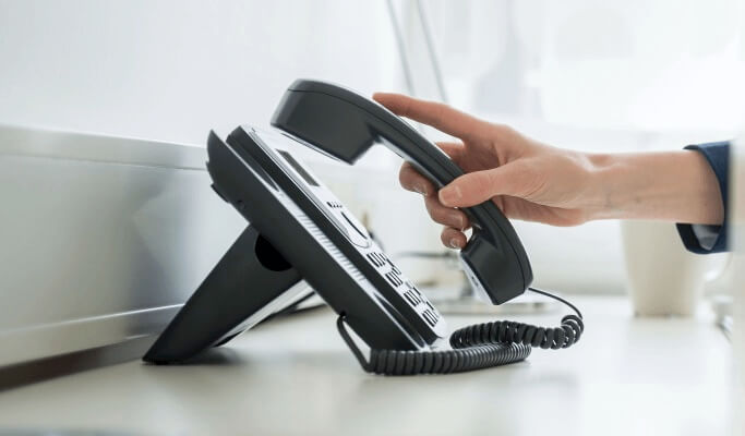 Hand picking up office phone