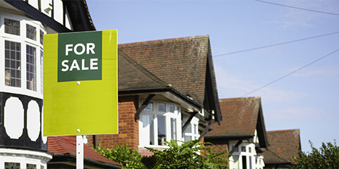 For sale sign outside houses