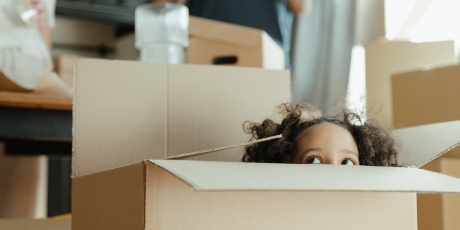 Child poking head out of box