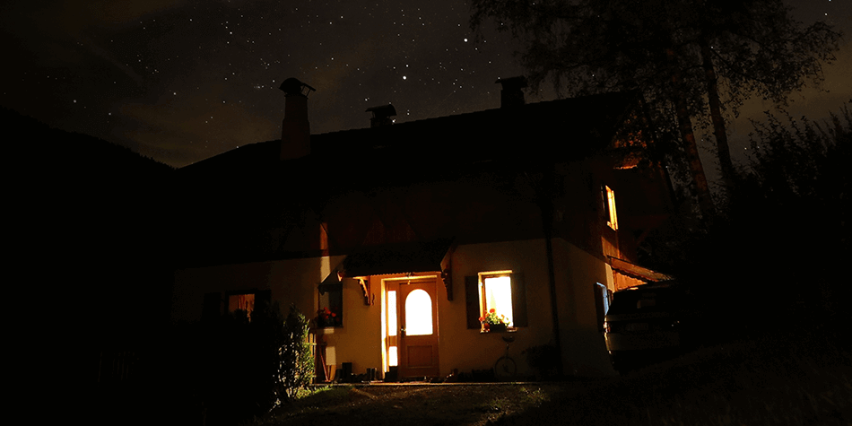 House at night with light through windows