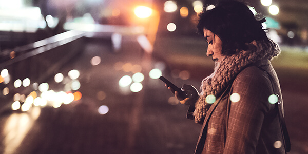 Lady looking at phone at night