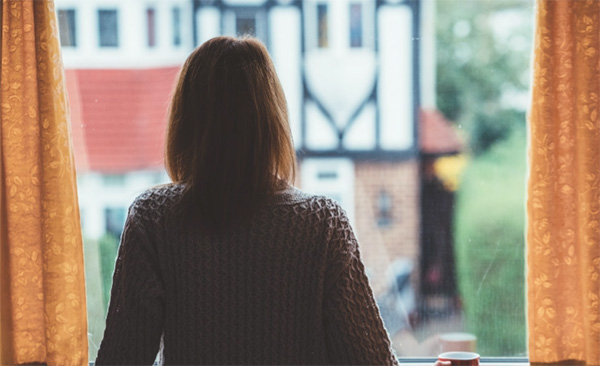 Lady looking out of window