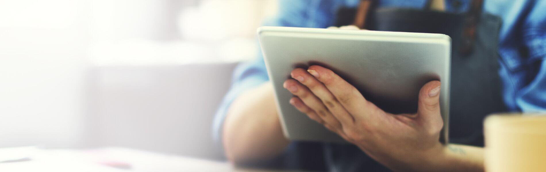 Torso shot of person using tablet