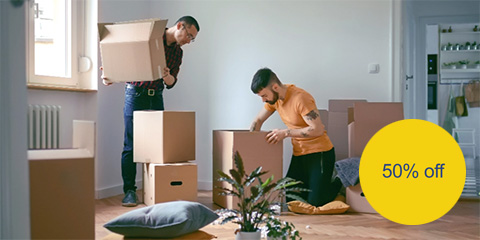Two men packing with 50% off circle