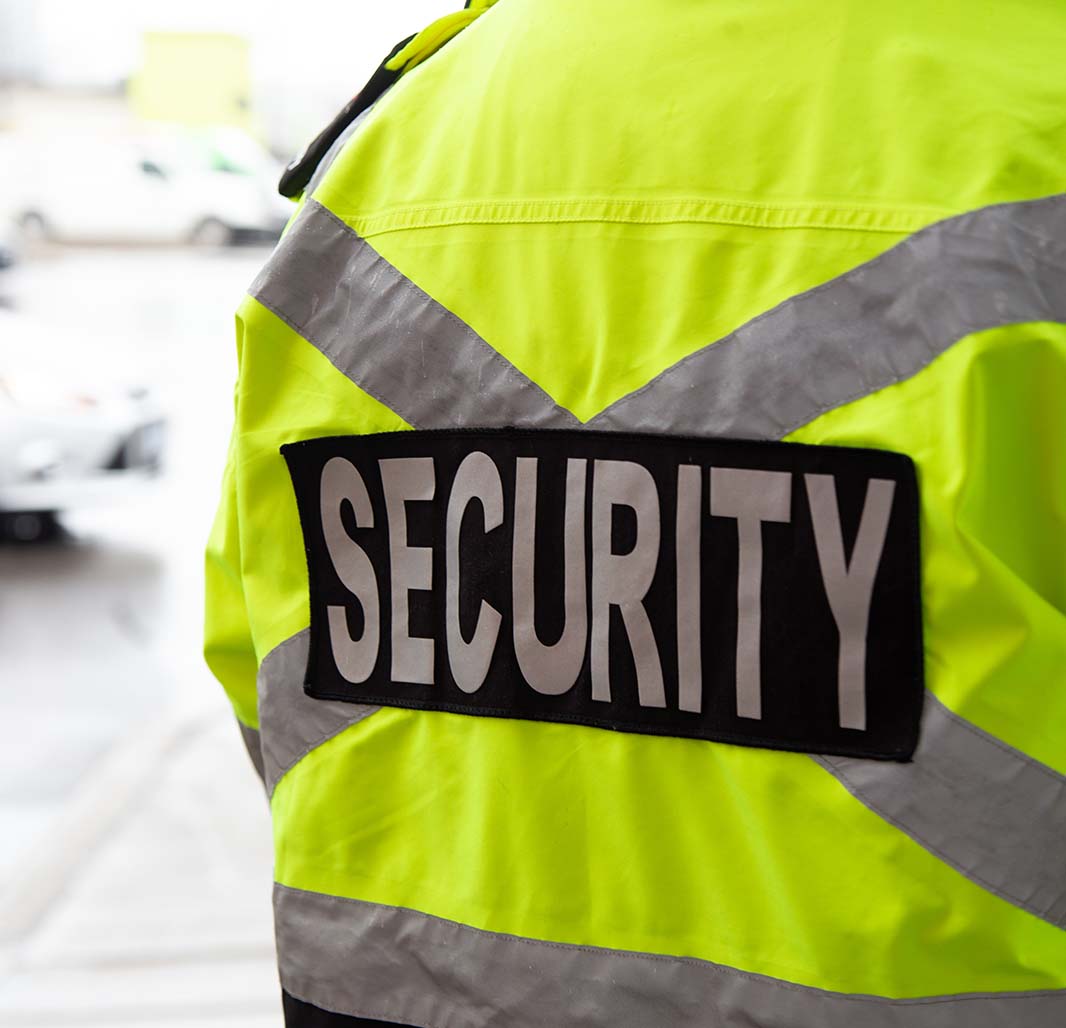 Posterior of person wearing hi-vis security jacket