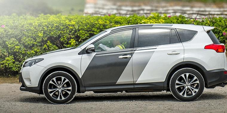 White SUV with black and grey stripes