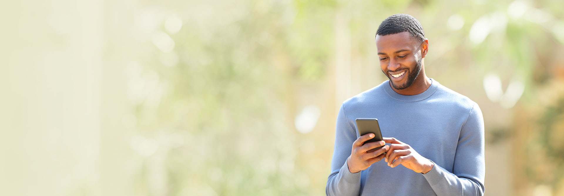 Man smiling using smartphone