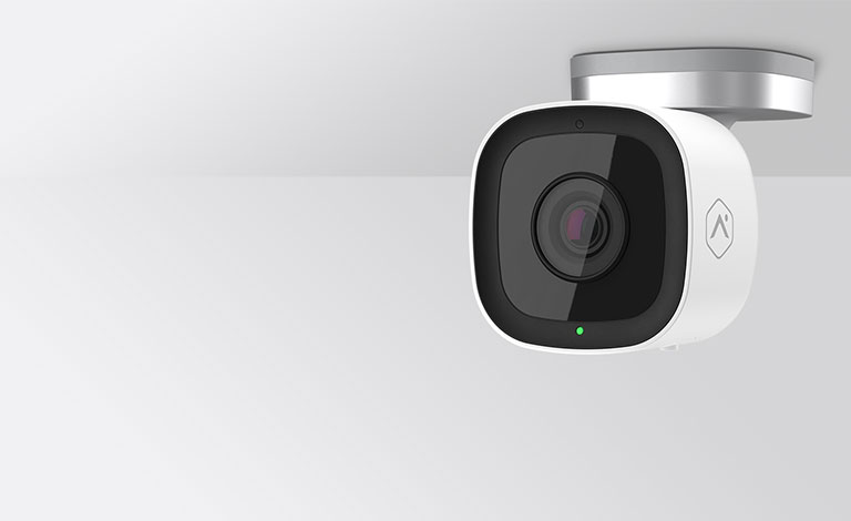White wall-mounted security camera